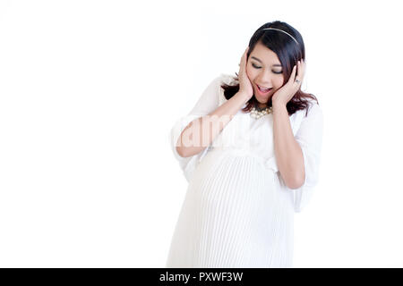 Heureux pregnant woman looking at her belly Banque D'Images