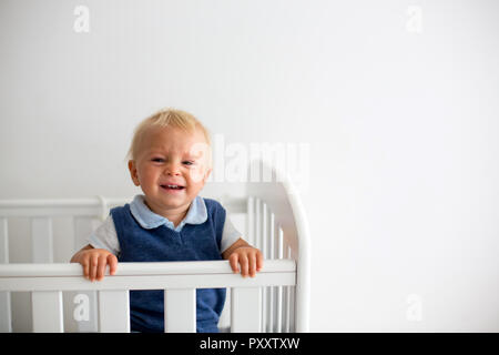 Triste Petit Bebe Garcon Bien Habille Se Sentir Malheureux Au Lit Bebe Regardant A Travers Les Barreaux Photo Stock Alamy