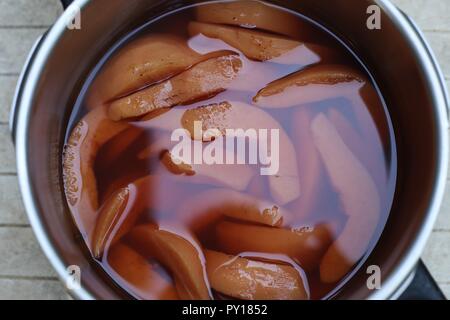 Plat avec des morceaux de coing. Pile de tranches de coing fraîches pelées dans un plat en verre avant d'être préparé pour le dessert. Banque D'Images