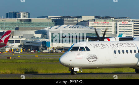 Détail de Sydney Kingsford Smith) (Aéroport de Sydney, en Australie, à l'égard du Terminal International à l'ouest de l'aéroport. Sur la photo : un avion Virgin Australia à taxying s'écarter de la piste nord-sud parallèle 16L/34R. Banque D'Images