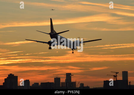 Un petit avion à turbopropulseur arrive sur terre à l'aéroport de London City au coucher du soleil Banque D'Images