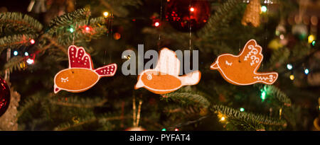 Mangeable décoration de Noël en forme d'oiseaux - gingerbreads suspendu à l'arbre de Noël avec des billes de verre et Garland Banque D'Images