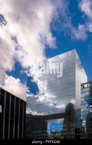 Qui se reflète sur les nuages d'un édifice moderne en verre Banque D'Images