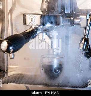 Photo spectaculaire d'une machine à expresso avec production de vapeur et de la vapeur d'eau ; concepts : cafe, café, espresso, cappuccino, latte, barista Banque D'Images