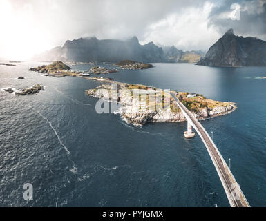 Vue panoramique aérienne de Reine village traditionnel de pêcheurs dans l'archipel des Lofoten en Norvège du Nord avec la mer bleue et les montagnes par temps ensoleillé arcti Banque D'Images