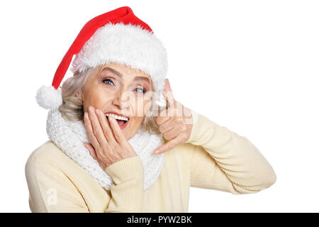 Magnifique Portrait de senior woman in Santa hat montrant Call me Banque D'Images