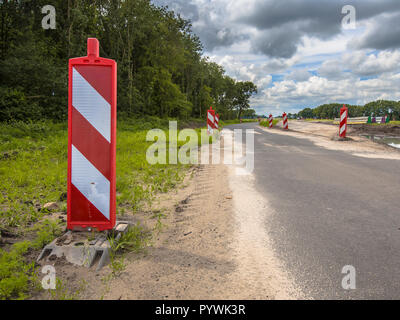 Travaux routiers avec des panneaux d'avertissement rouge et blanc Banque D'Images