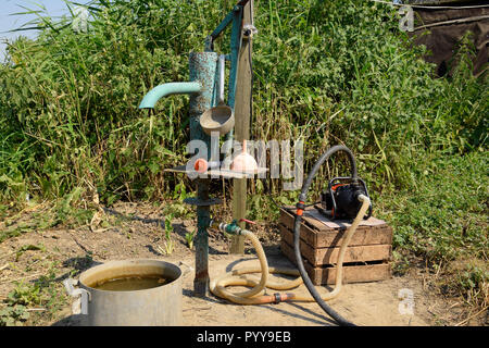 Système d'irrigation dans le jardin. Bien avec la pompe manuelle et automatique. Banque D'Images