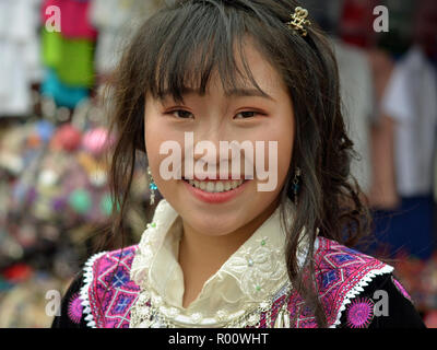 Jolie fleur vietnamiens H'Mong adolescente weas son clan tenue traditionnelle au cours de l'hebdomadaire marché de dimanche. Banque D'Images