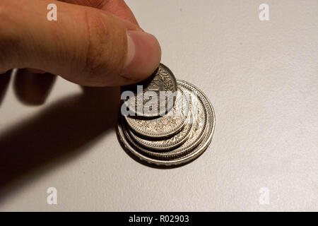 Doigts de la main humaine prenant coin de coin stack de francs Suisse Banque D'Images