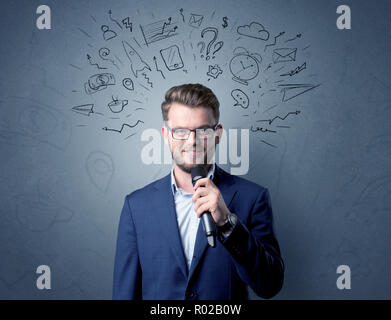 Businessman parlant au micro avec des doodles sur sa tête Banque D'Images