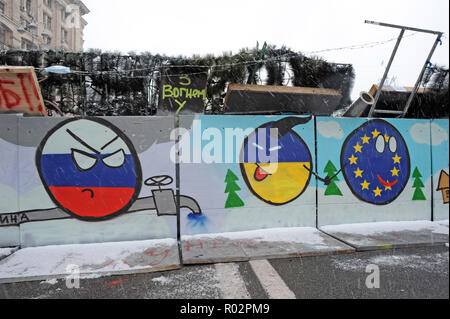 7 décembre 2013 - Kiev, Ukraine : une barricade de la place de l'Indépendance de Kiev avec dessins représentant l'Ukraine de rejoindre l'Europe au détriment de la Russie et de son gaz de la diplomatie (représenté par un pipeline sur le dessin). Des milliers de manifestants ukrainiens se sont réunis à la place de l'indépendance, rebaptisée "EuroMaidan', pour protester contre leur rejet par le gouvernement d'un accord commercial historique avec l'Union européenne (UE). Barricade de l'ONU avec des émoticônes représentant la Russie, l'Ukraine, et l'Union europŽenne prés de la place de l'Independance a Kiev, ou des dizaines de milliers de personnes manifestent contre la déc Banque D'Images