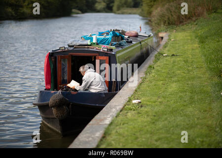 Un homme se lit sur un grand classique sur la navigation Weaver Banque D'Images