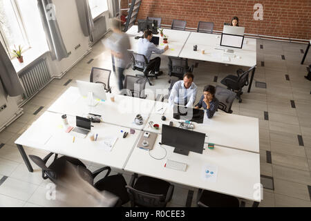 Coworking modernes avec les gens de l'équipe travaillant sur les ordinateurs, vue du dessus Banque D'Images
