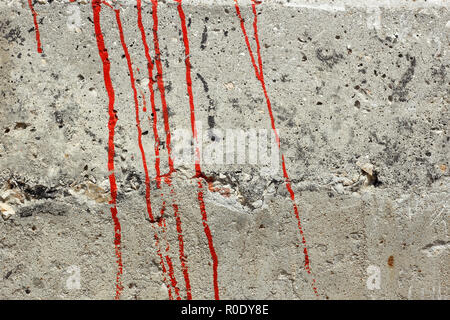 Des traces de peinture rouge sur un mur en béton comme une texture Banque D'Images