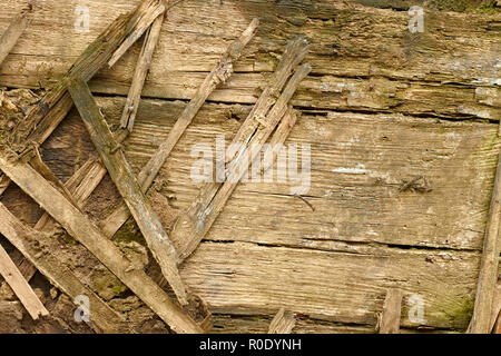 Détail d'un vieux murs en bois délabrées. Des lattes de bois sont utilisés comme le montage avec de la boue Banque D'Images