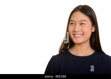 Les jeunes professionnels Asian teenage girl smiling et pensée Banque D'Images