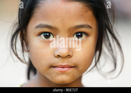 BHAKTAPUR, NÉPAL, 24 novembre 2010 : Portrait d'une petite fille népalaise posant dans le principal square Bhaktapur Banque D'Images