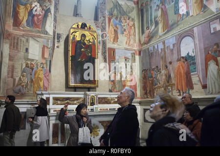 Les visiteurs asiatiques assister à une visite guidée de la Chapelle Brancacci (Chapelle Brancacci) dans l'église de Santa Maria del Carmine à Florence, Toscane, Italie. Fresques de Masaccio et peintres de la Renaissance italienne Masolino da Panicale (1420-1427) a achevé de Filippino Lippi (1485) sont vus dans l'arrière-plan. Banque D'Images