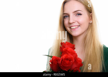 Close up of young teenage girl smiling while holding red r Banque D'Images