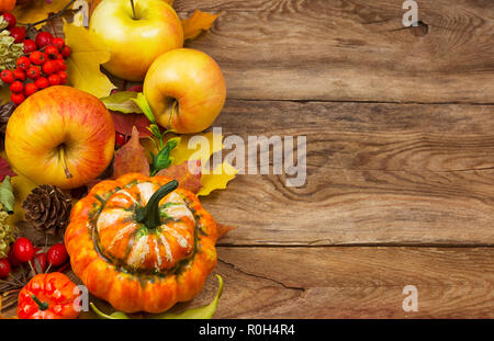 Fond de carte de vœux rustique avec des citrouilles, pommes, cônes et jaune feuilles d'automne, copy space Banque D'Images