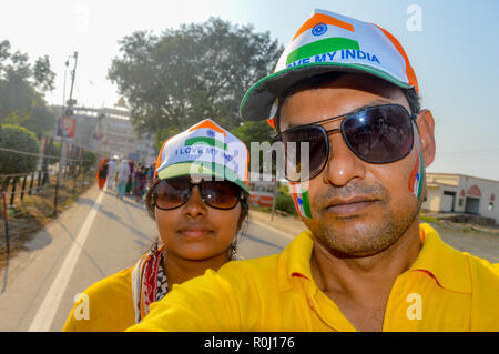 Selective focus sur l'homme. Fans de Cricket avec visage peint en 3 couleurs indiennes. Happy young couple aimant looking at camera. La capture de papasov joyeux lumineux Banque D'Images