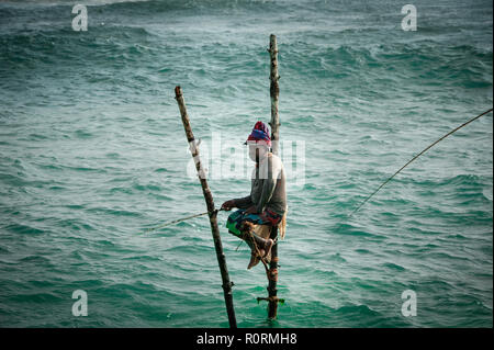 Le fameux pêcheurs de Koggala. Homme assis sur Local pôle de bambou, la pêche dans la manière traditionnelle. Banque D'Images