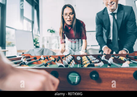 Close-up shot of woman playing table football in modern office Banque D'Images