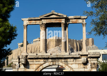 Athènes. La Grèce. Arc romain d'Hadrien aka la porte d'Hadrien, avec le Parthénon et Acropole en arrière-plan. (Fronton du niveau supérieur). Banque D'Images