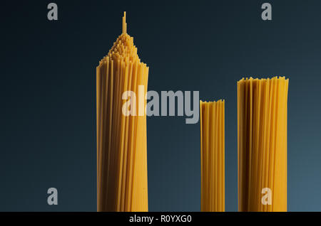 Trois grappes de matières en forme de spaghetti crus comme tower structures contre fond gris Banque D'Images