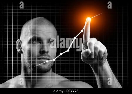 Jeune homme d'affaires en affaires avec un concept graphique. Jeune homme sportif montre avec son index un point de croissance sur un tableau noir sur un background isolés Banque D'Images