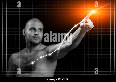 Jeune homme d'affaires en affaires avec un concept graphique. Jeune homme sportif montre avec son index un point de croissance sur un tableau noir sur un background isolés Banque D'Images