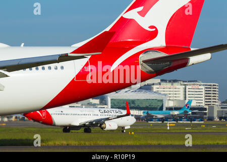 Détail de Sydney Kingsford Smith) (Aéroport de Sydney, en Australie, à l'égard du Terminal International à l'ouest de l'aéroport. Sur la photo : un Airbus A330-202 de Qantas (call sign VH-EBB) taxying, avec un Boeing 737-800 de Qantas (call sign VH-VN900) dans l'arrière-plan. Banque D'Images