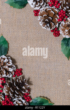 Télévision à Noël arrangement laïcs de cocottes, fruits rouges et des feuilles de houx Banque D'Images