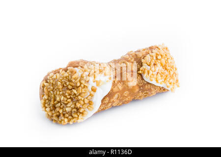 Cannolo sicilien avec grains de noisette, isolé sur fond blanc. Banque D'Images