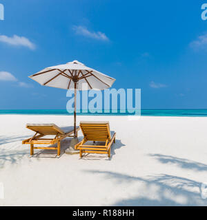 Couple parfait et l'amour romantique fond de plage. Deux chaises longues et parasol sur la plage de sable blanc près de la mer. Maison de vacances de luxe et concept Banque D'Images