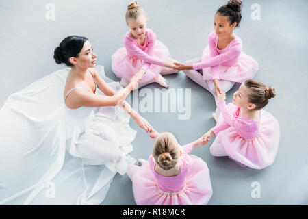 Peu de ballerines et professeur de ballet qui exercent ensemble dans l'école de ballet Banque D'Images