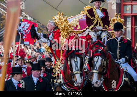 Londres, Royaume-Uni. 10 Nov, 2018. Le maire dans son chariot d'or - le nouveau Maire (Peter Paul Eluard, le 691st) a prêté serment hier. Pour célébrer, aujourd'hui, c'est le Seigneur annuel Show du maire. Il comprend des bandes militaires, vintage bus, Dhol tambour, une moissonneuse-batteuse et un chien dans la tête géant trois milles de long cortège. Il rassemble plus de 7 000 personnes, 200 chevaux et 140 Moteur et les véhicules à moteur à vapeur dans un événement qui remonte au 13e siècle. Le maire de la ville de Londres en état d'entraîneur. Banque D'Images