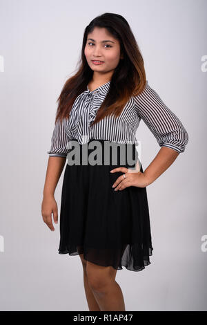 Studio shot of young happy fat Persian businesswoman smiling whi Banque D'Images