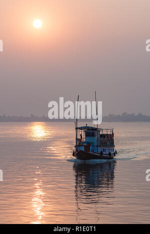 Un traversier pour passagers bateau est découpé sur le coucher de soleil dans les Sundarbans, le Bengale occidental, en Inde. Banque D'Images