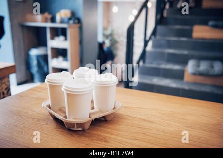 Prendre le café à travailler pour l'ensemble du bureau. High angle shot d'un carton de prendre le bac avec quatre tasses de café avec couvercles Banque D'Images