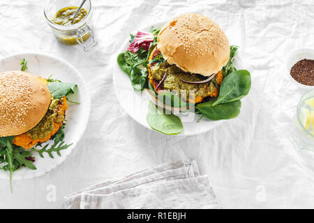 Burger végétarien fait de l'escalope de citrouille, Épinards, roquette et sauce pesto servi sur assiette. Concept de l'alimentation végétarienne saine Banque D'Images