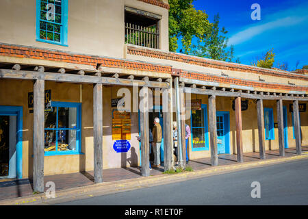 Les gens se promener sur les colonnades historique dans le shopping, restaurant, et galerie d'art district de centre-ville de Santa Fe, NM pendant le coucher du soleil Banque D'Images