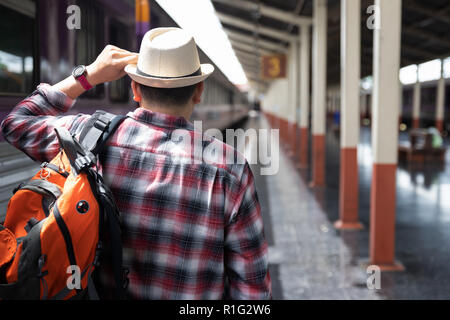 Voyageur asiatique homme avec effets personnels en attente de voyager par train à la gare de Chiang Mai, Thaïlande Banque D'Images