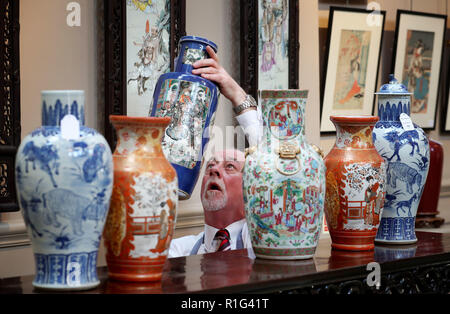 Maison de vente aux enchères sous Danny McIlwraith examine de plus près un 19e siècle vase de style Kangxi qui est affichée à l'Bonhams, Édimbourg avant il est mis aux enchères dans le cadre d'une vente d'art asiatique jeudi prochain. Banque D'Images