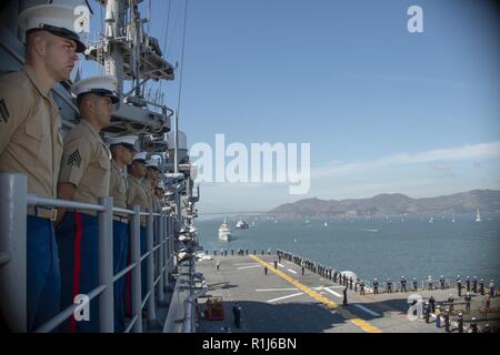 SAN FRANCISCO (oct. 5, 2018) Les Marines et les marins, affecté à l'assaut amphibie USS Bonhomme Richard (DG 6), l'homme les rails pendant le défilé des navires dans le cadre de la semaine de San Francisco en 2018. San Francisco Fleet Week est l'occasion pour le public américain pour satisfaire leur marine, Marine Corps et les équipes de la Garde côtière canadienne et l'expérience de la mer du Nord. Au cours de la semaine de la flotte, les militaires participent à divers événements de service communautaire, vitrine de l'équipement et les capacités de la communauté, et profiter de l'hospitalité de San Francisco et ses environs. Banque D'Images