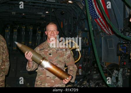 Le Lieutenant-colonel de l'armée américaine Jessie Griffith, commandant du 925e Bataillon du contractant, est titulaire d'un fortement explosif M102 105 mm Howitzer round lors d'une tournée à l'intérieur d'un AC-130W Stinger II alors qu'il combat bataille circulation à Al Asad Air Base (AAAB), l'Iraq, 5 octobre 2018. AAAB est une combinaison d'un groupe de travail conjoint - Fonctionnement amélioré la capacité inhérente de résoudre partenaire emplacement consacre à la formation des forces des partenaires et renforcer leur efficacité. Banque D'Images