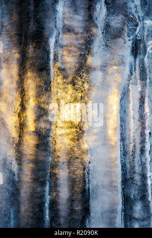 Belle texture glace éclairé par derrière. Glace et soleil, chaud et froid, l'hiver et le printemps, concept de résistance Banque D'Images