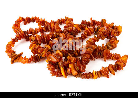 Chaîne de perles d'ambre baltique isolé sur fond blanc. Collier ambre orange vif de matières perles en un tas. Banque D'Images