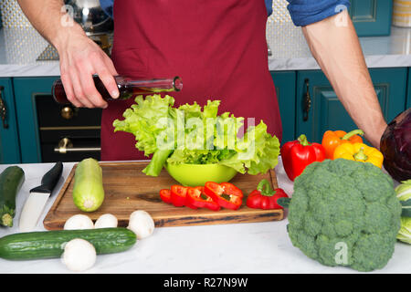 Mesurer avec précision. Rien d'épaves plat comme une double portion de vinaigre ou d'huile. Mains des hommes chef pouring laitue avec du vinaigre ou l'huile sans mesure. Les questions de mesure peut entraîner le gaspillage de produits. Banque D'Images